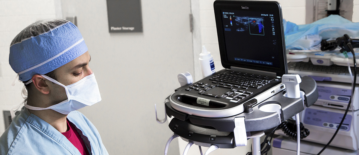 Resident using ultrasound technique