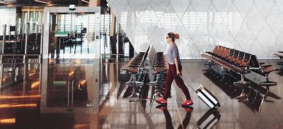 A person walking through an empty airport.