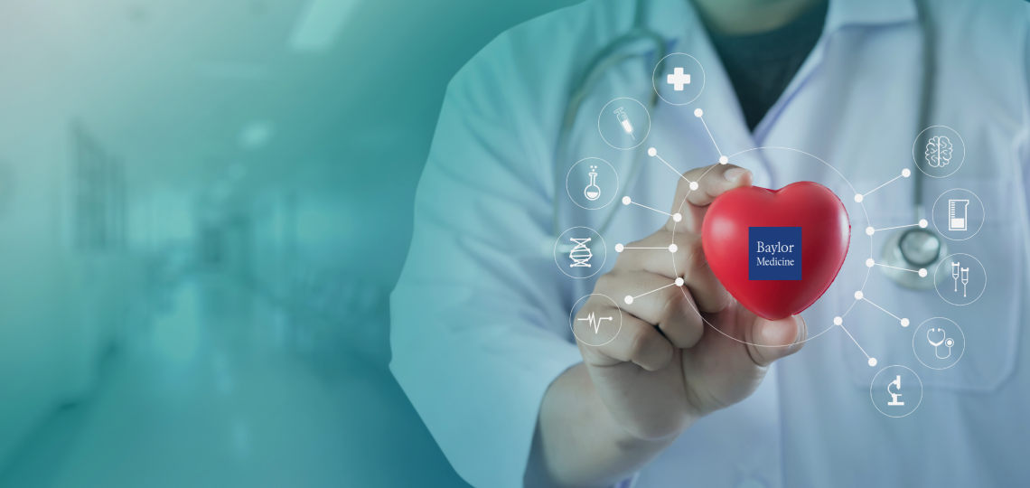 A hand holding a red heart with the Baylor medicine logo.