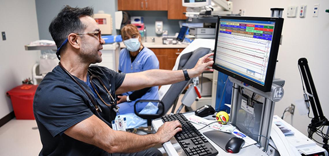 , Dr. Francisco Orejuela meets with a patient to discuss her urodynamic test results.