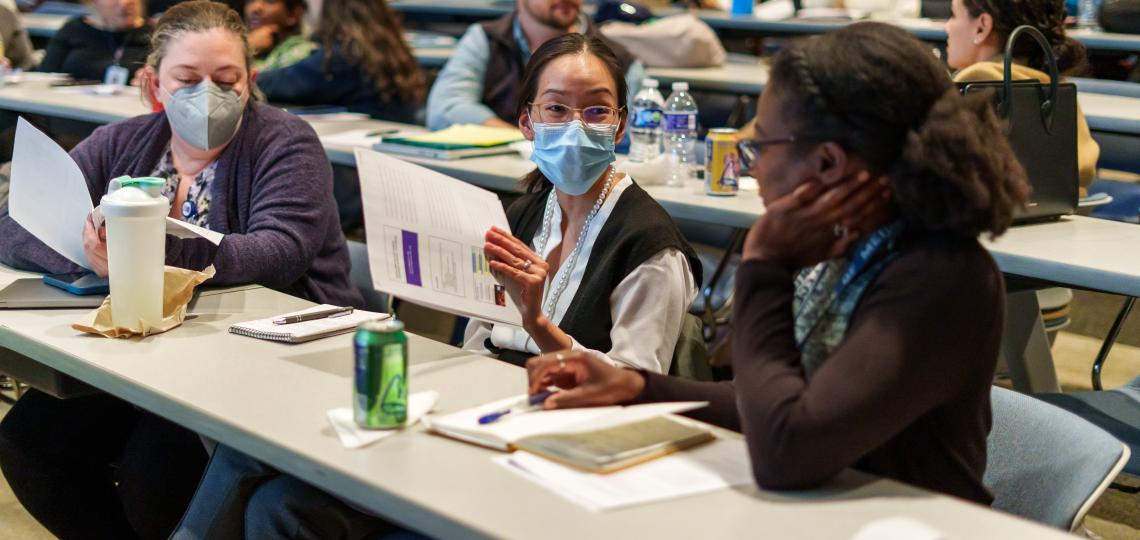 Trainee sitting at tables in a classroom