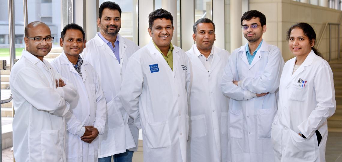 group of doctors standing in front of a window