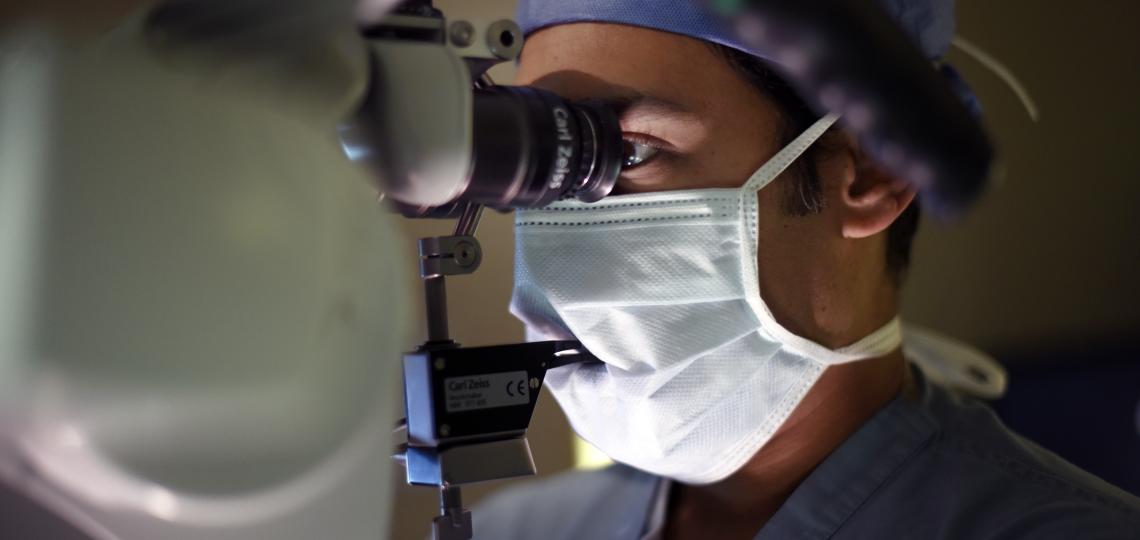 Scientist utilizing a microscope