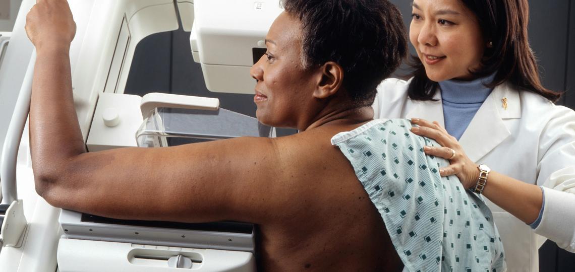 woman receiving breast examination by machine