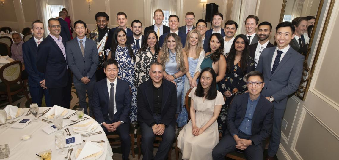 group of people dressed nicely in a dining room, smiling