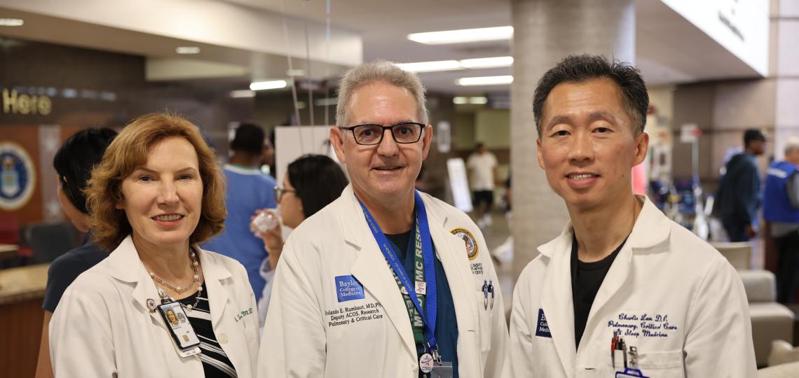three doctors in white coats smiling