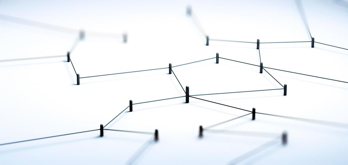 a group of pins with string stretched among them