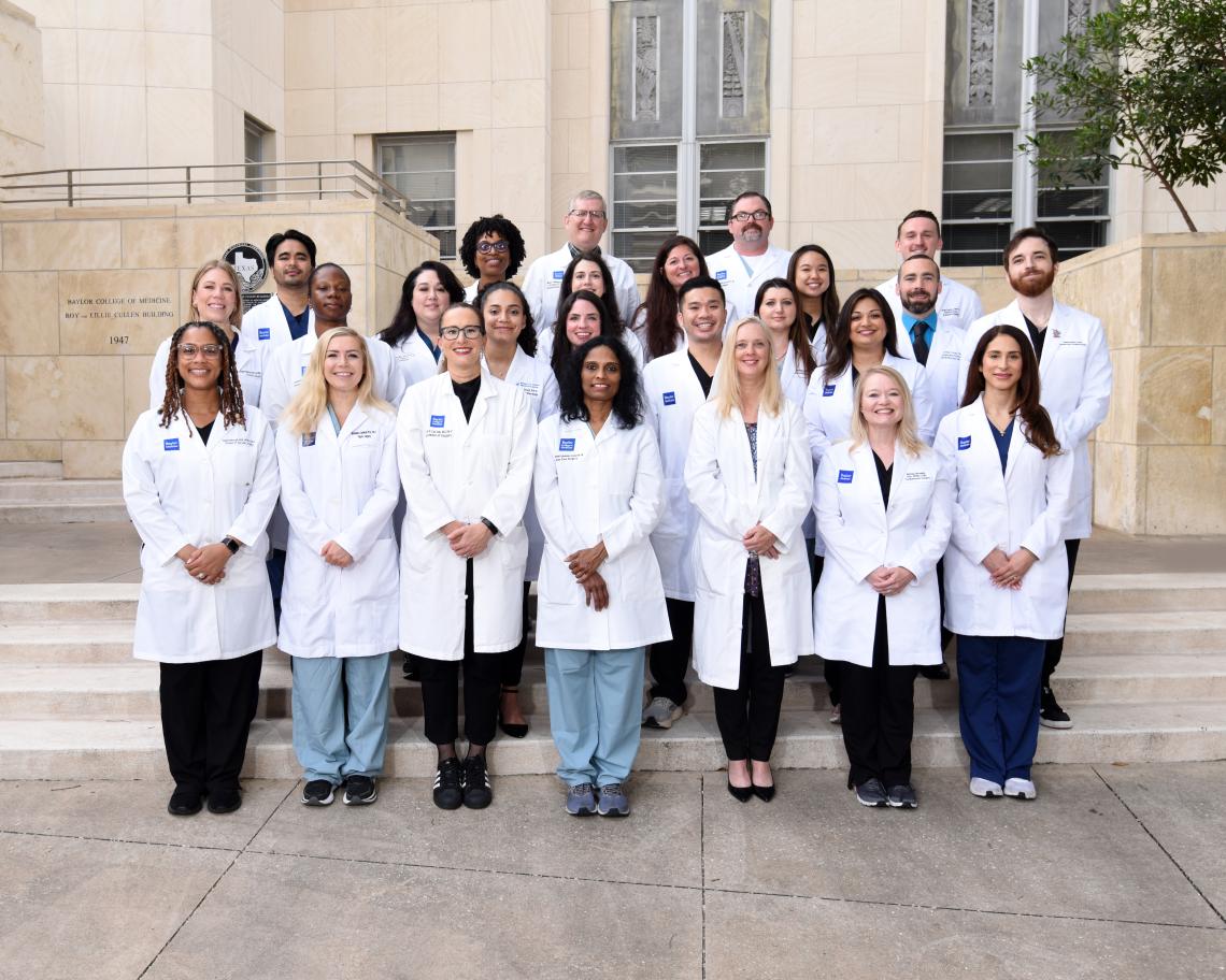 group of doctors standing together outside, smiling