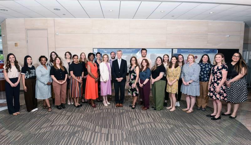 group of people dressed nicely, standing together smiling