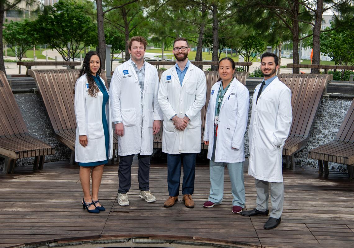 5 doctors standing outside smiling