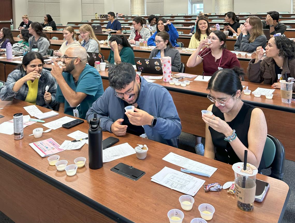 people sitting at desks, trying baby formula
