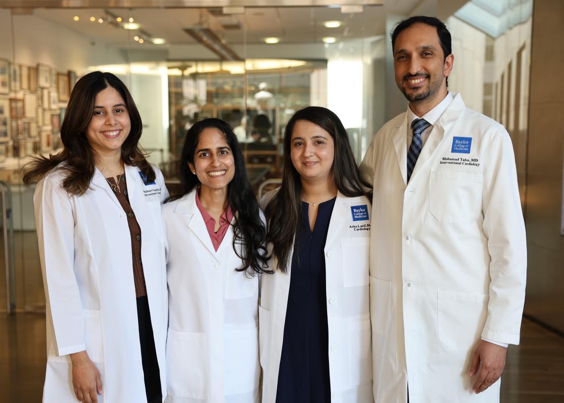 4 doctors standing together smiling