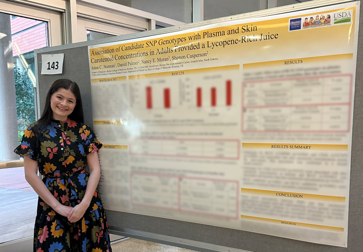 Photo of Norman Anna standing in front of her poster at HNORC