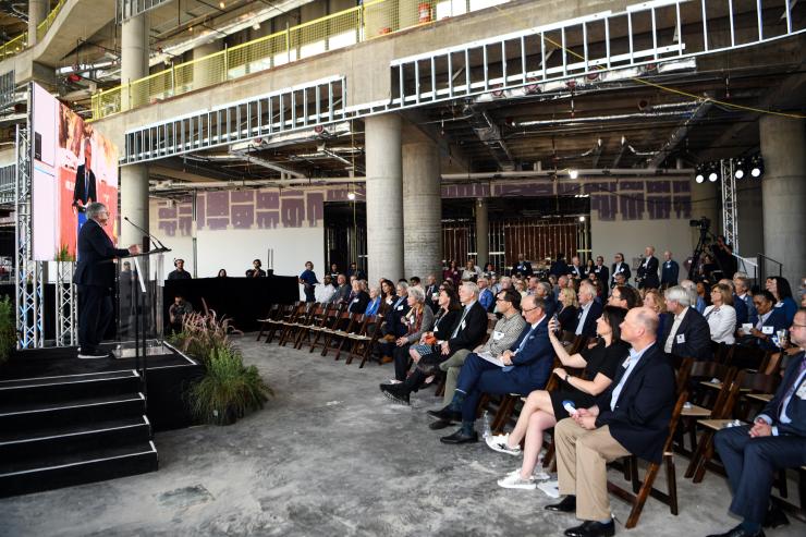 Dr. Paul Klotman addresses those gathered to celebrate the tree topping ceremony at the Lillie and Roy Cullen Tower
