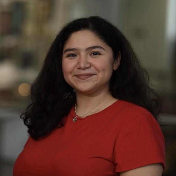 woman smiling in front of grey background