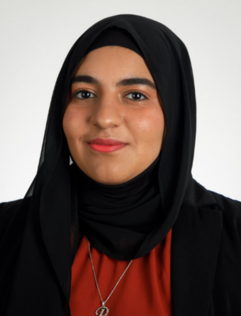 woman with a red top on smiling lightly