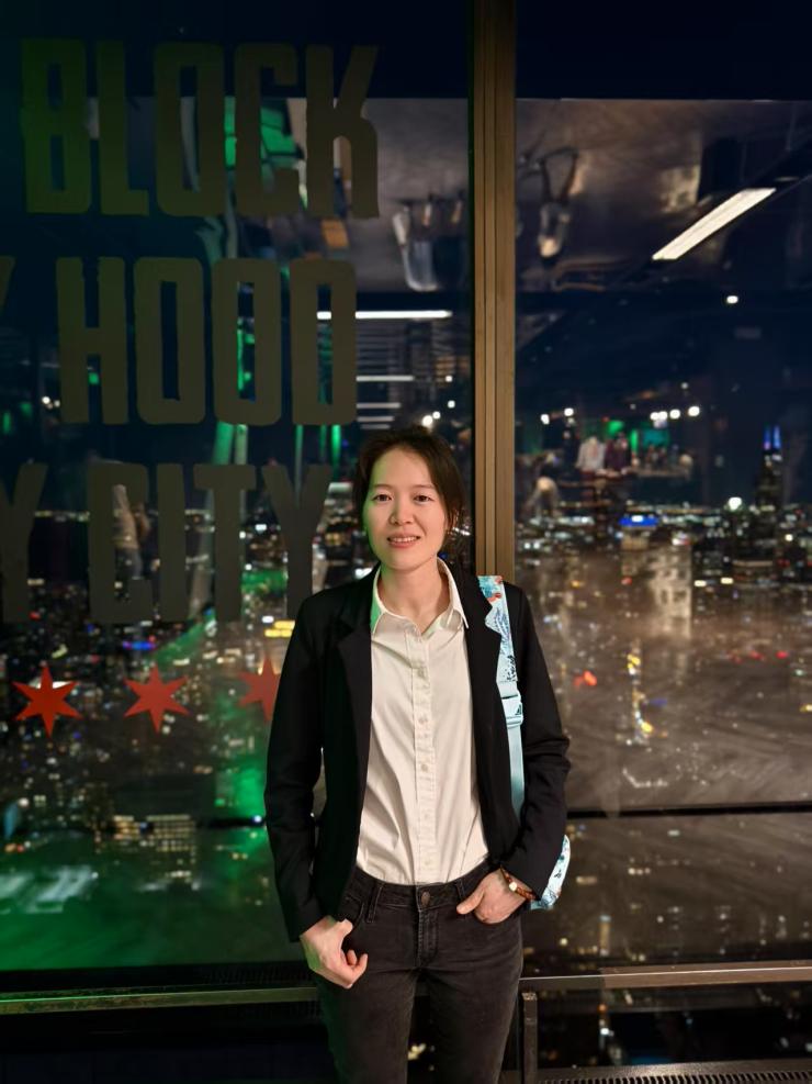 meng yu smiling in front of a window