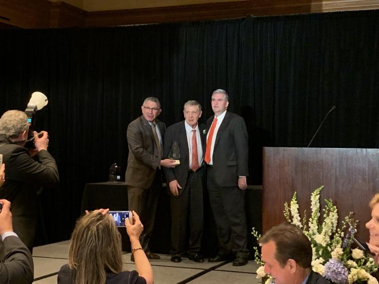 Dr. George P. Noon (center) is presented with the Distinguished Service Award.