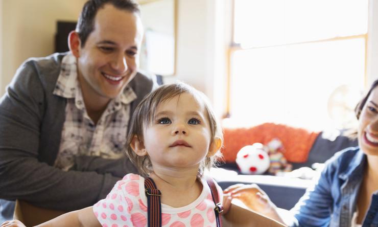 A family of three playing at home.
