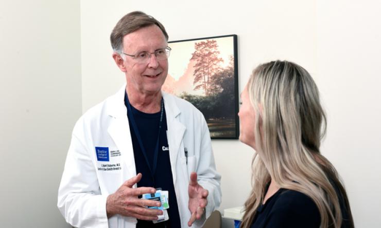 Doctor facing patient and having a conversation.