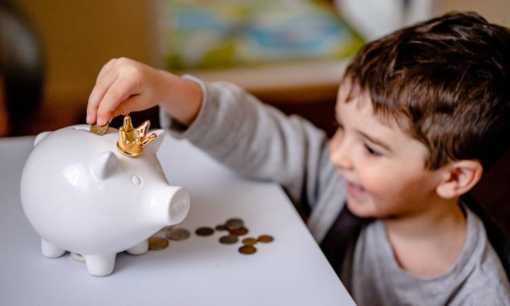 A child saving money in a piggy bank