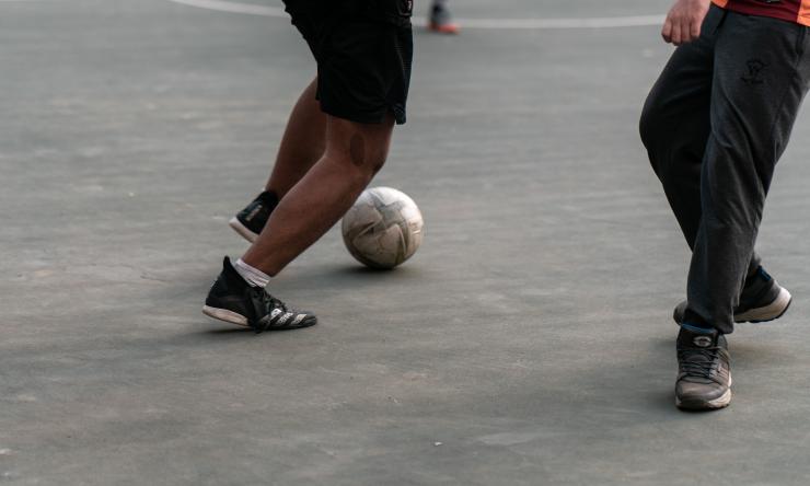 Photo of people playing soccer on a basketball court