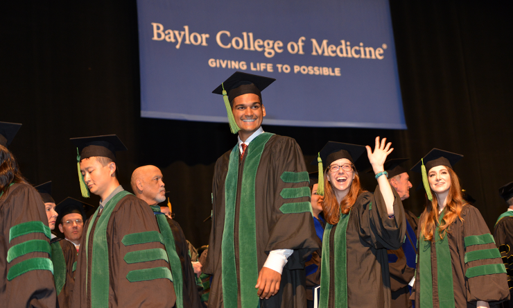 Students walk across the stage during Graduation 2017.